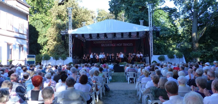 Das Foto zeigt die Sommerlichen Musiktage auf Hof Trages mit Besuchern vor der Bühne